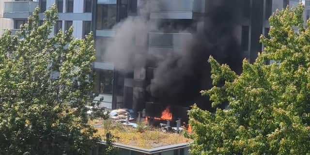 Fire rages at 22-storey tower block.